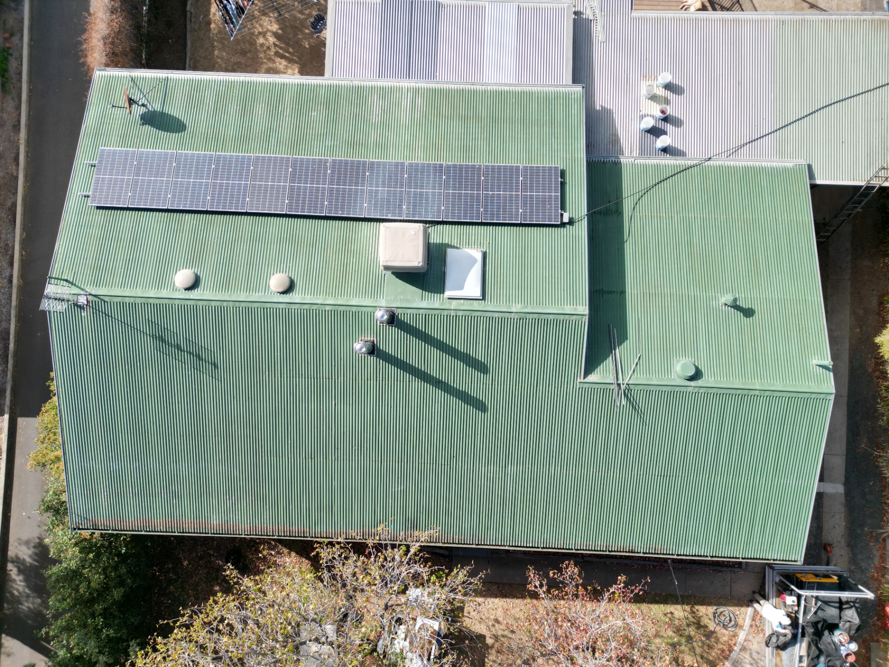 Top-Down Drone Photo of a Restored Green Corrugated Colorbond Roof With Solar Panels