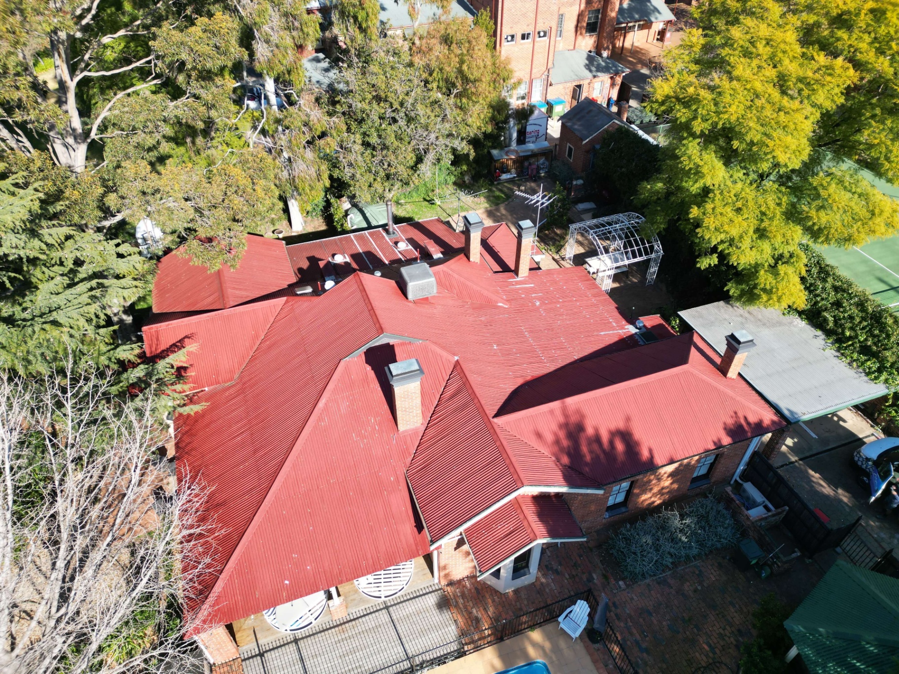 Aerial view of a Tamworth Colorbond roof with solar panels before its Monument repaint