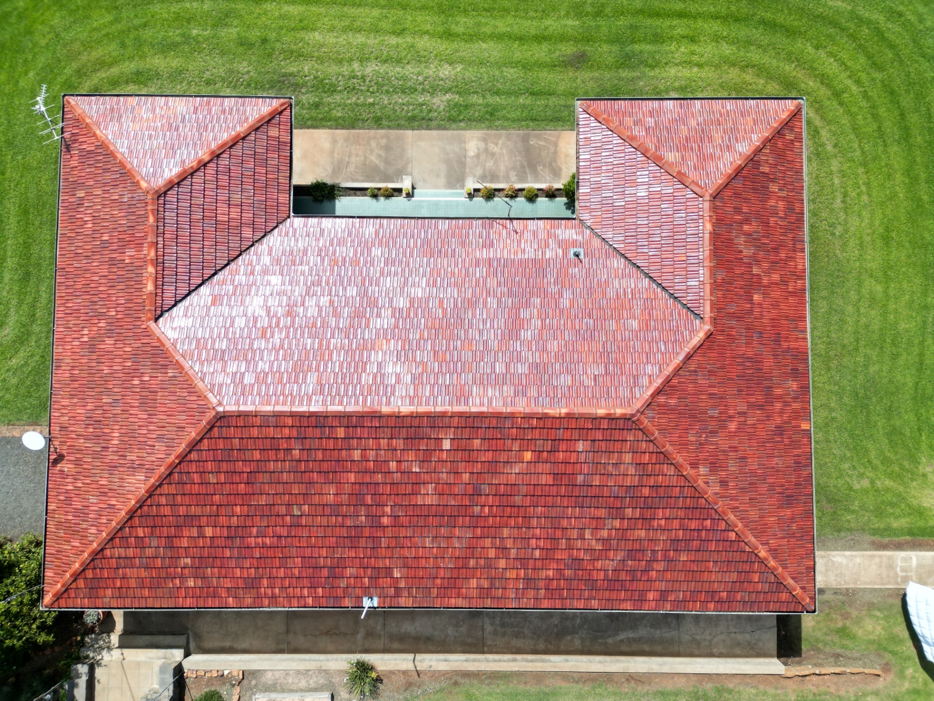 The same Gunnedah terracotta roof after cleaning, repairs and sealing, back to an even terracotta colour