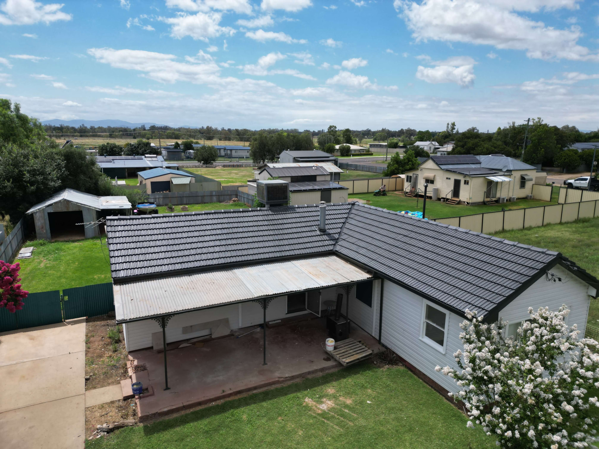 Aerial view of a Narrabri home with a freshly restored charcoal concrete tile roof and recoated metal veranda roof