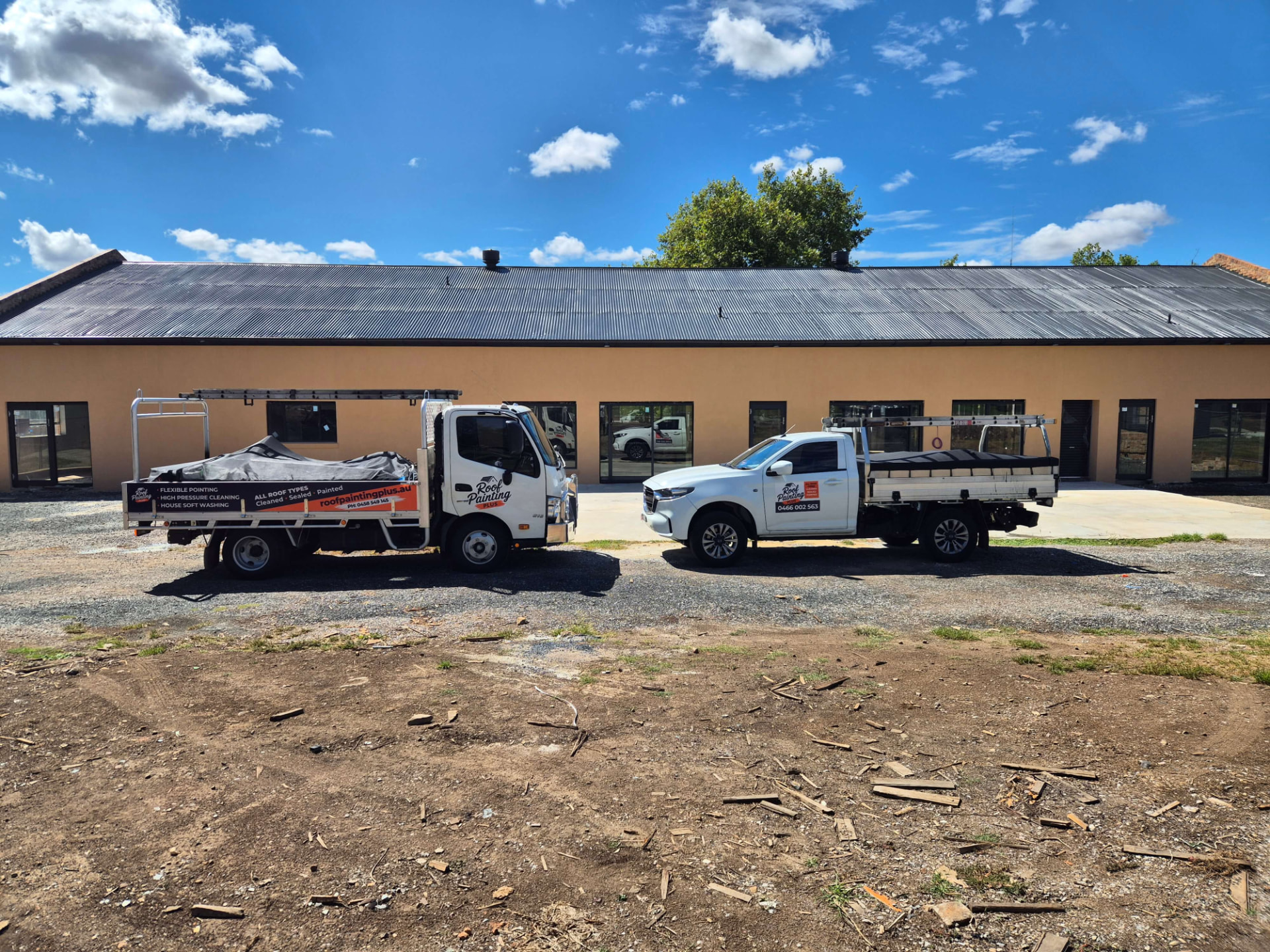 Roof Painting Plus truck and ute parked side by side at a job site