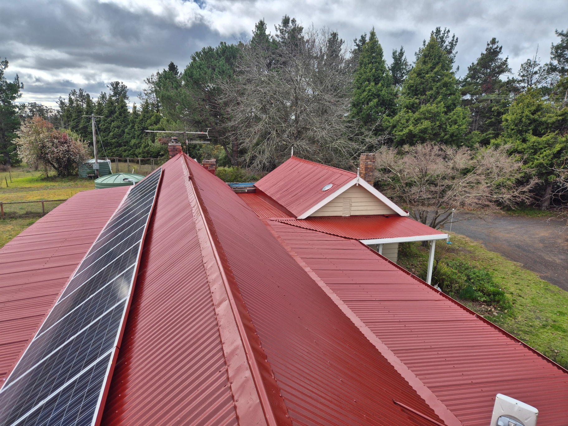 Restored Manor Red Corrugated Iron Roof on a Heritage Cottage With Solar Panels