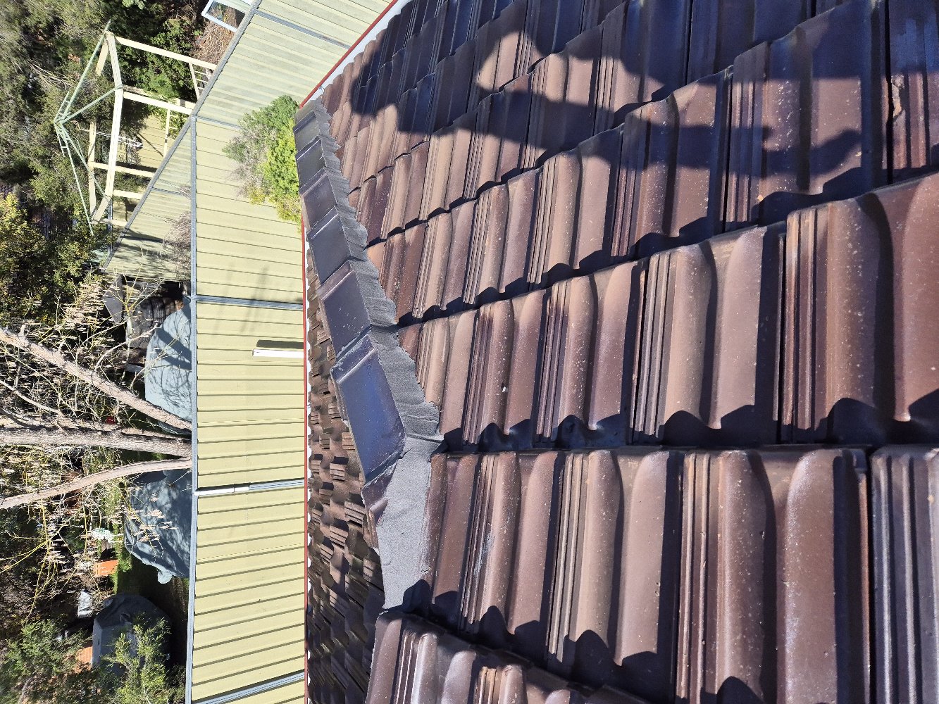 Ridge Caps on a Brown Tile Roof Re-Bedded and Finished in Fresh Grey Flexible Pointing