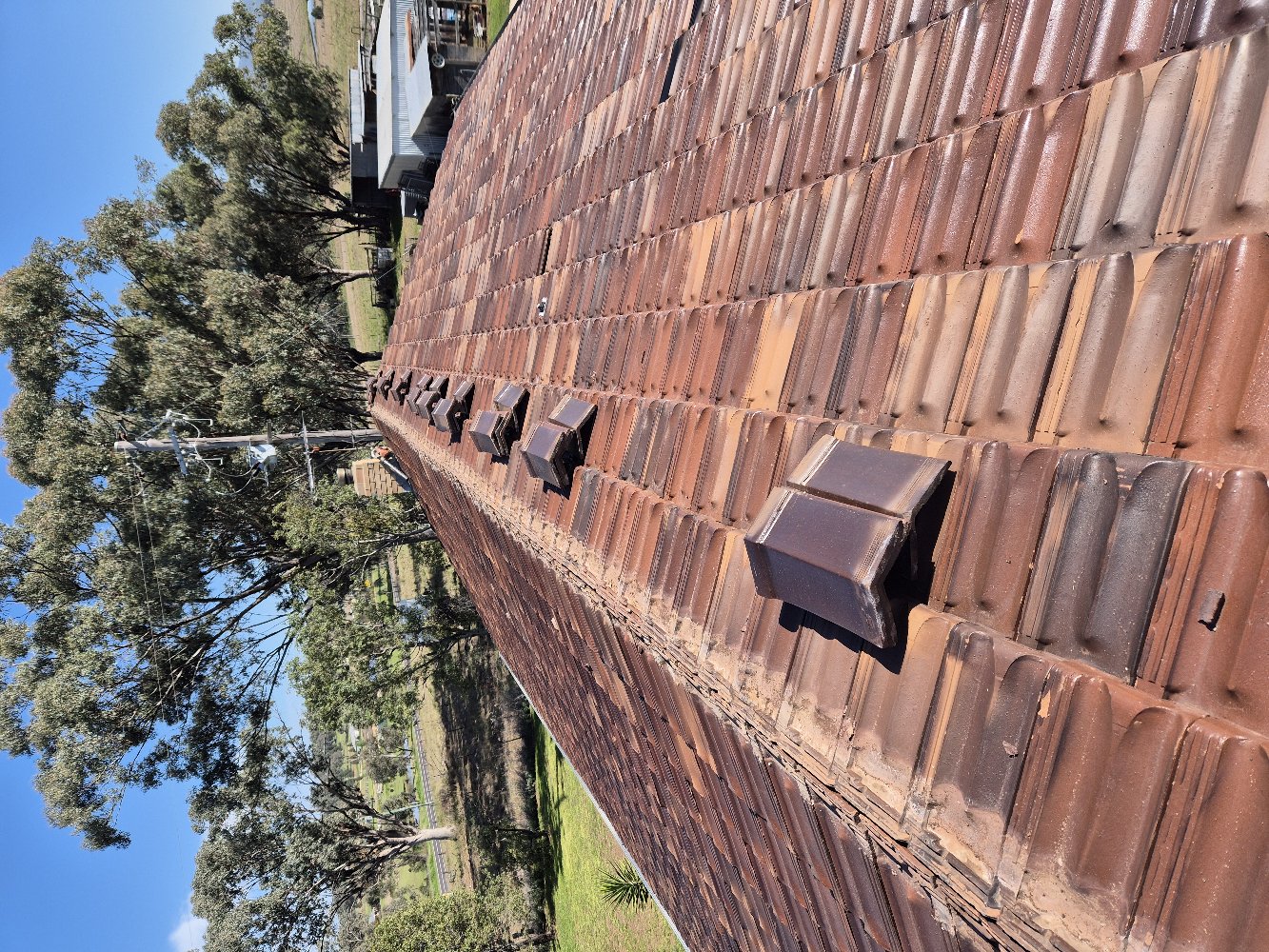 Cracked, crumbling cement pointing with loose ridge caps lifted off