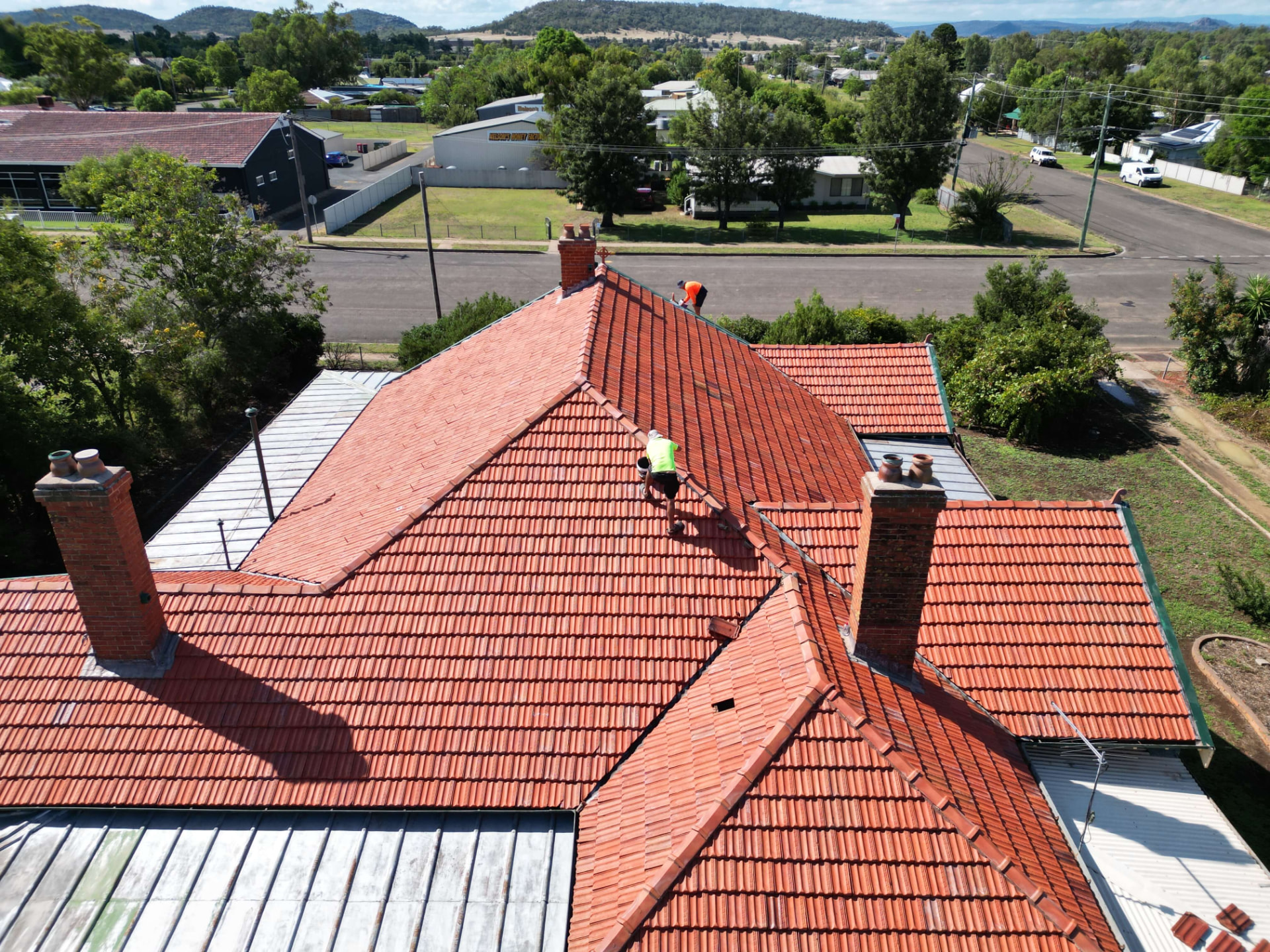 Two Roof Painting Plus Crew Working Across a Gunnedah Terracotta Tile Roof Mid-Restoration