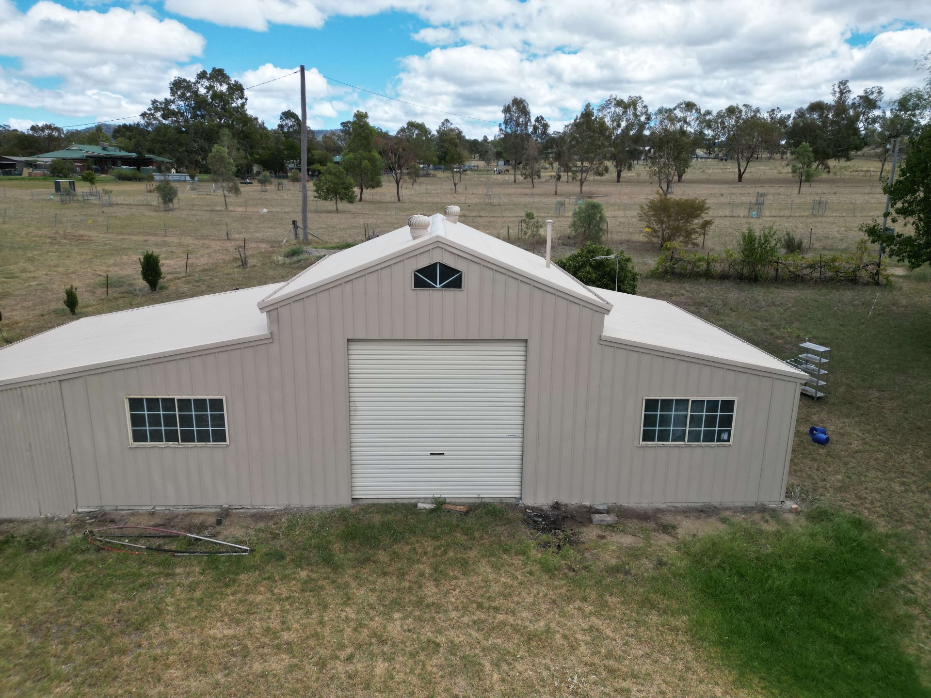 Aerial of the Same Rural Shed After a Full Roof and Wall Repaint in Warm Stone