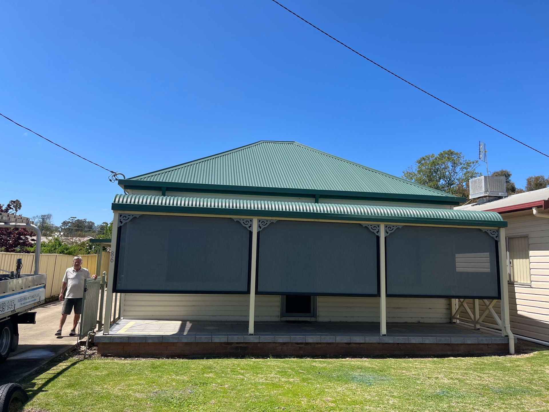 Street view of a Werris Creek weatherboard cottage with its restored Wilderness green Colorbond roof and verandah trim