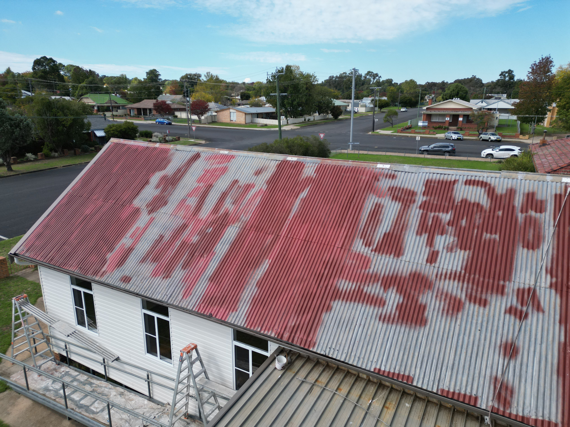 Aerial of a Cottage Corrugated Iron Roof With Flaking Red Paint Before Restoration
