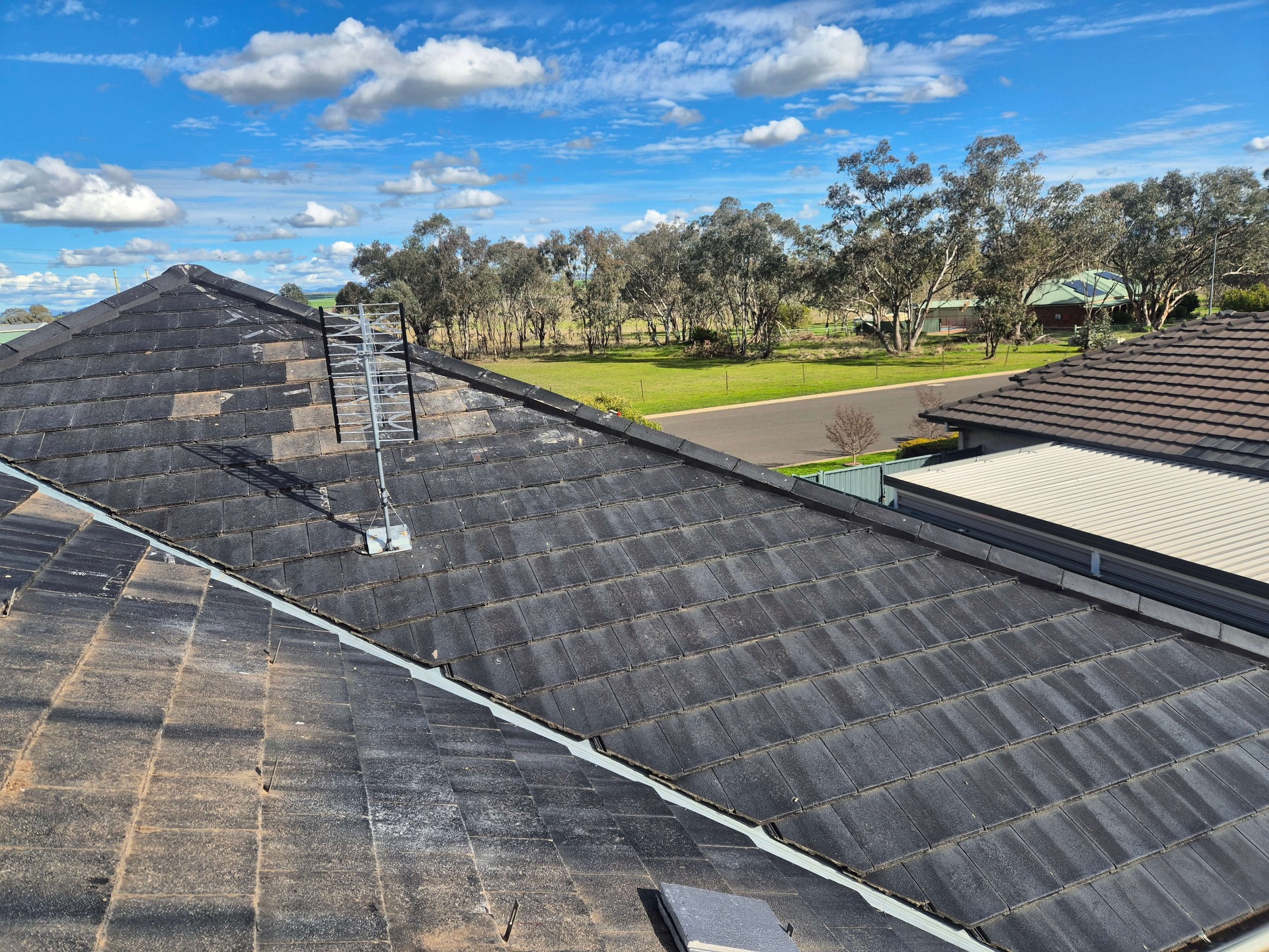 Repaired Tile Roof After Storm Damage With New Tiles Bedded In Across the Main Run