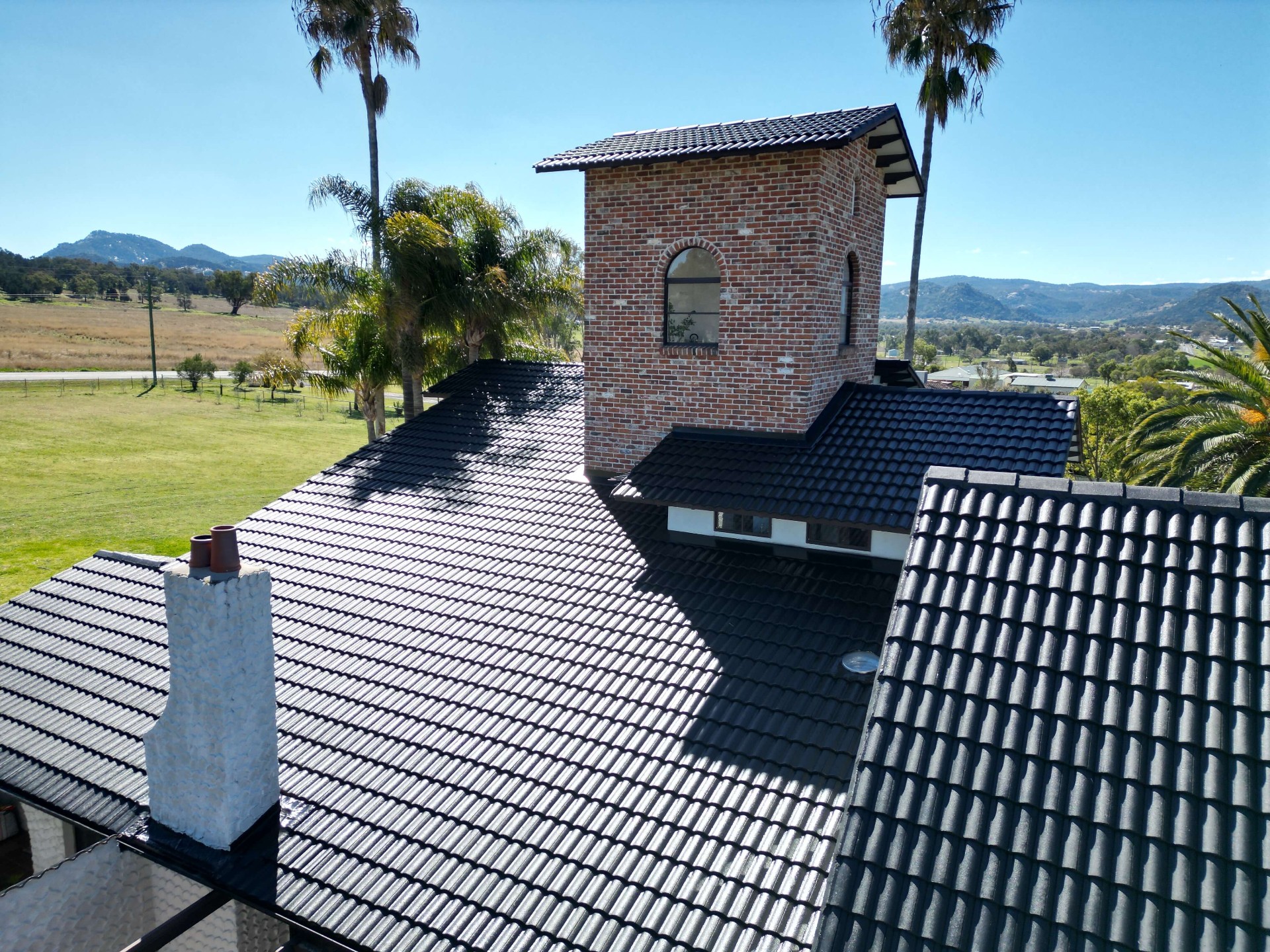 Aerial of a Spanish Mission Homestead With Newly Restored Black Tile Roof and Brick Tower
